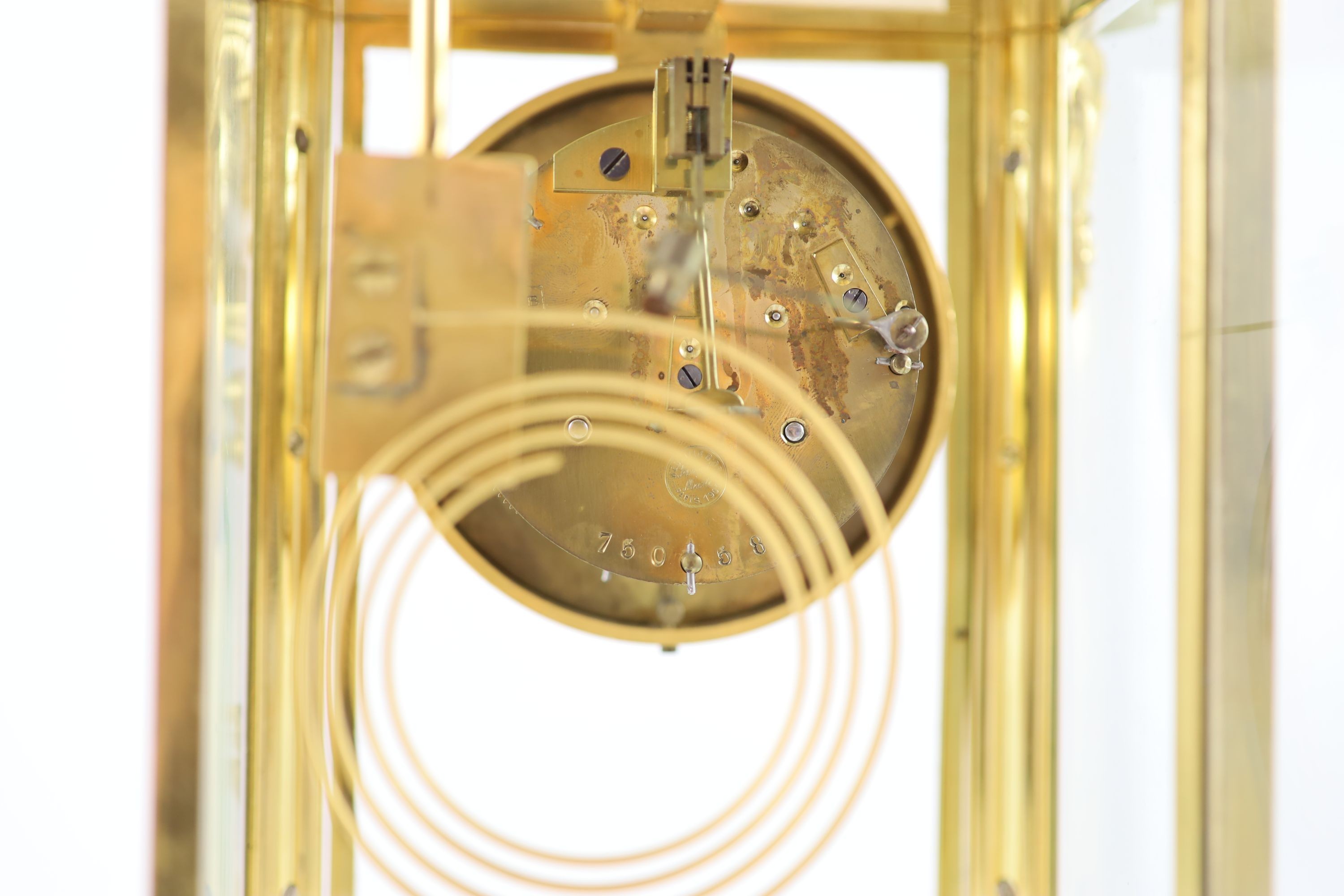 A green onyx and gilt metal clock garniture, comprising a four-glass regulator with enamelled dial in serpentine case and a pair of pedestal urns and covers Clock H 35cm. W 27cm. Urns H 36cm.